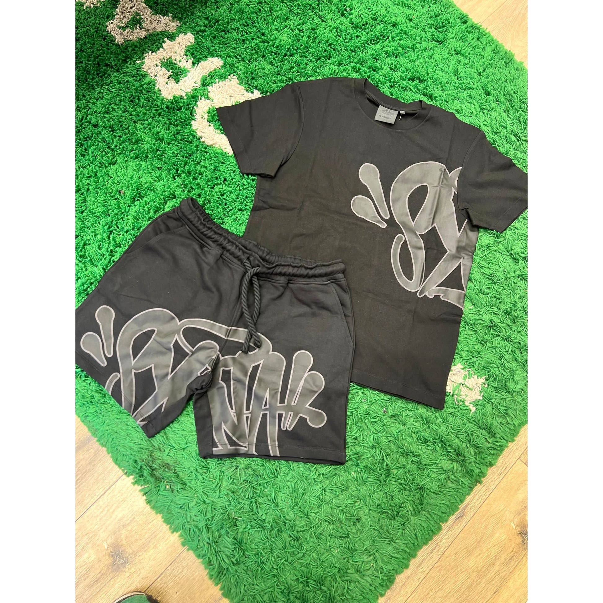 SYNA WORLD LOGO T SHIRT & SHORT SET - BLACK by SYNA in Clothing. Available at KershKicks for £225.00. A must-have for fans of SYNA looking to elevate their style with this Hoodie.