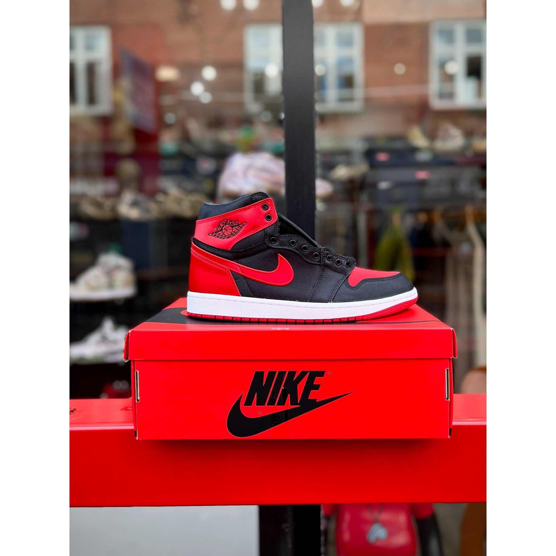 Jordan 1 Retro High OG Satin Bred (Women's) by Jordan's in Shoes. Available at KershKicks for £175.00. A must-have for fans of Jordan's looking to elevate their style with this Shoes.