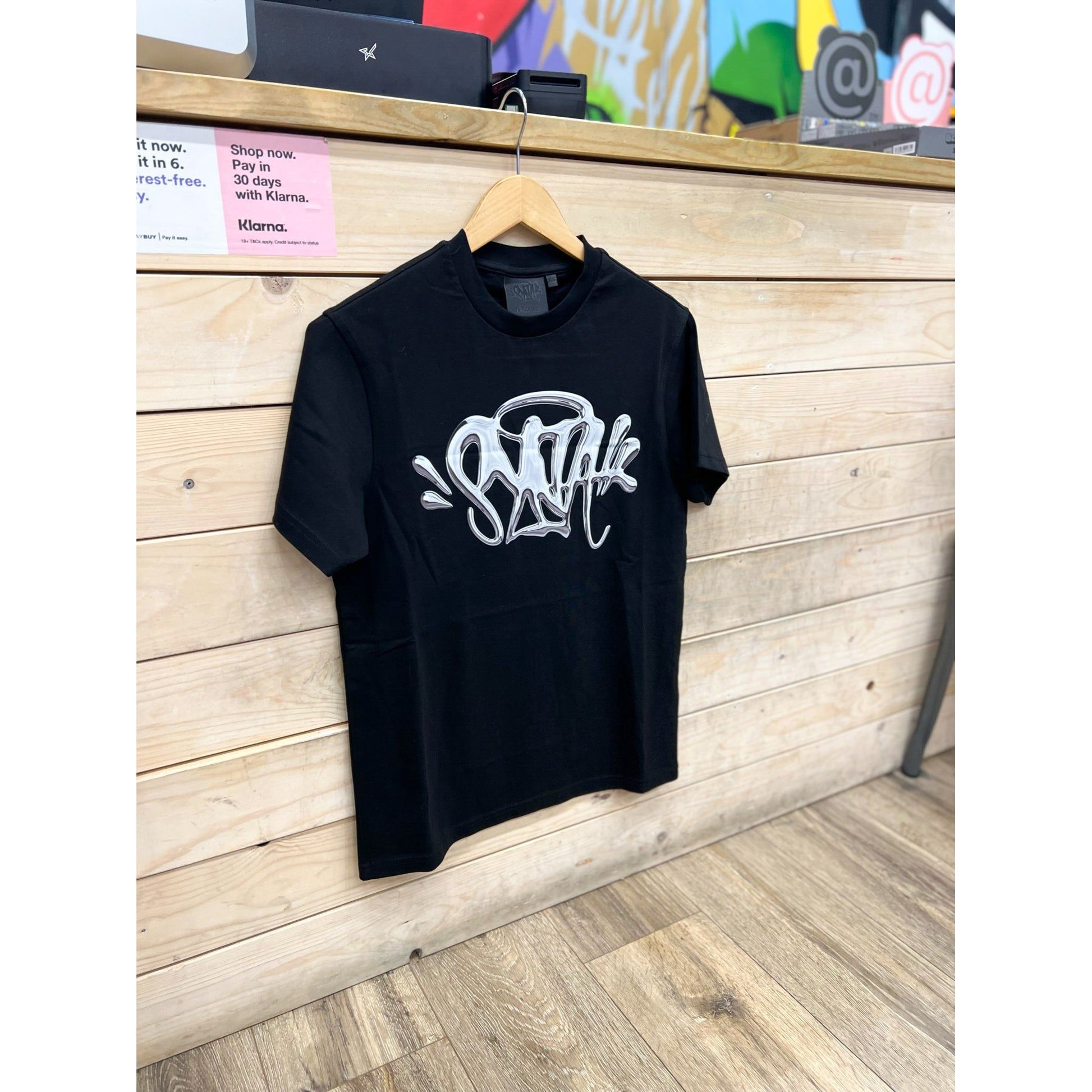 Syna World Chrome T-Shirt Black by SYNA in Uncategorized. Available at KershKicks for £60.00. A must-have for fans of SYNA looking to elevate their style with this T-Shirt.