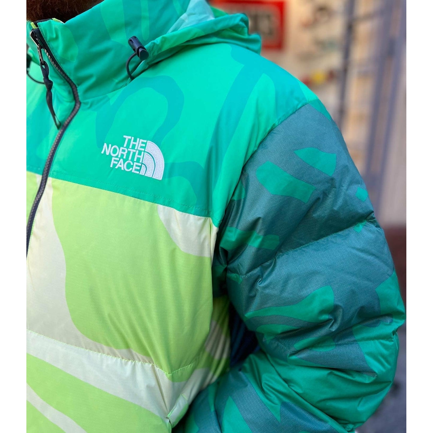 KAWS x The North Face Retro 1996 Nuptse Jacket Safety Green by Kaws in Clothing. Available at KershKicks for £300.00. A must-have for fans of Kaws looking to elevate their style with this Jacket.